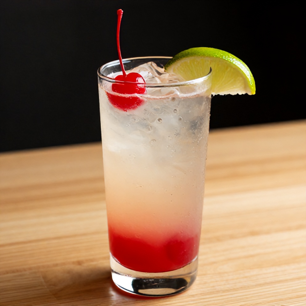 Glass of Cherry Limeade with a cherry and lime wedge garnish