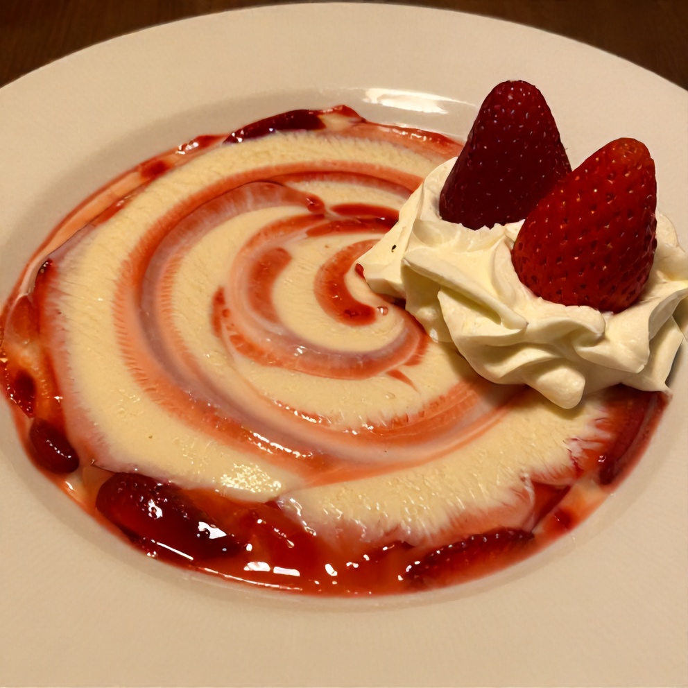 Sliced creamy strawberry swirl cheesecake on a dessert plate